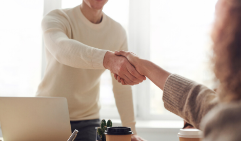 two people shake hands